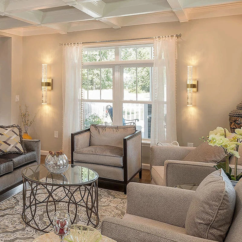 Modern bubble crystal LED wall sconces mounted on a light beige wall beside a large window.