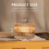 A clear glass tealight candle holder with a 1.6-inch diameter, shown on a wooden surface.
