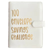 A white leather binder for the 100 Envelope Savings Challenge with gold text on the cover.