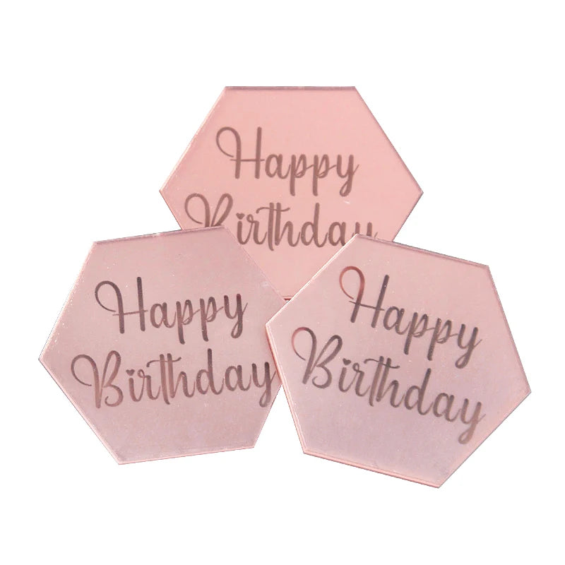 A set of ten pink acrylic birthday message toppers with the text Happy Birthday
