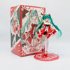 A PVC collectible figurine of a female anime character dressed in a red and white outfit, standing on a circular base.
