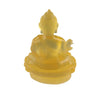 A handcrafted resin statue of the Medicine Buddha in a golden yellow color.
