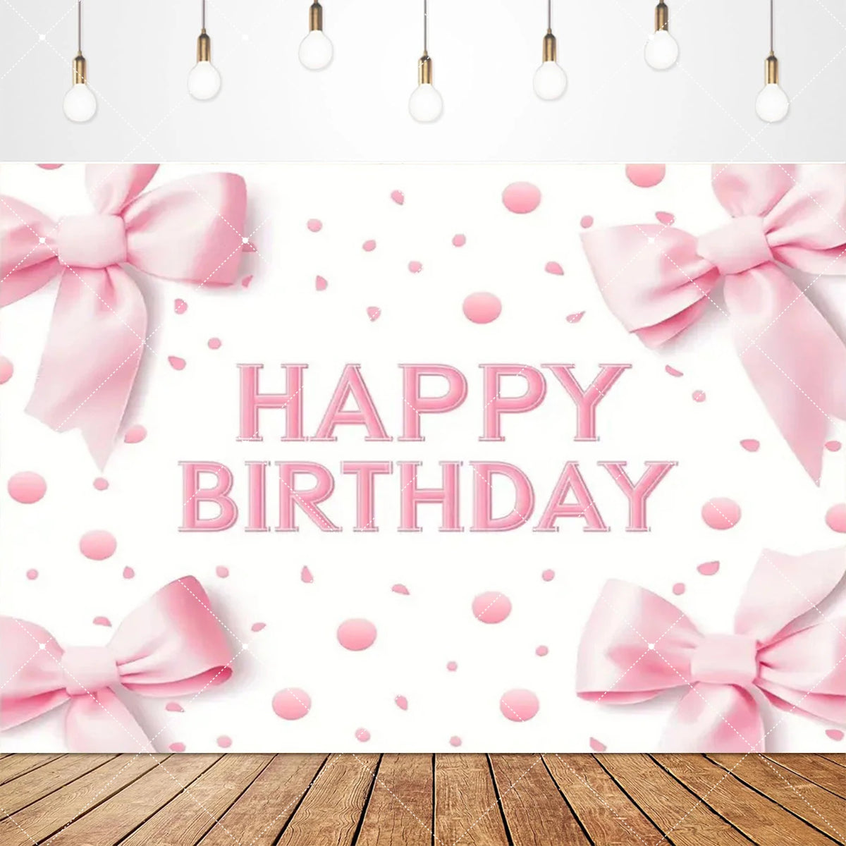 Pink bow tie birthday party backdrop banner with scattered pink confetti and wooden surface