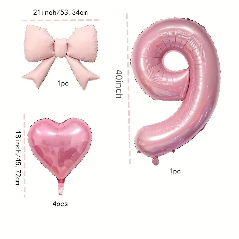 Pink foil balloons shaped like a bow, heart, and number 9 for party decoration