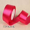 A roll of bright pink silk satin ribbon used for gift wrapping and craft projects.