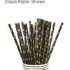 A bundle of 25 paper straws with black and gold polka dots stored in a white cylindrical container.