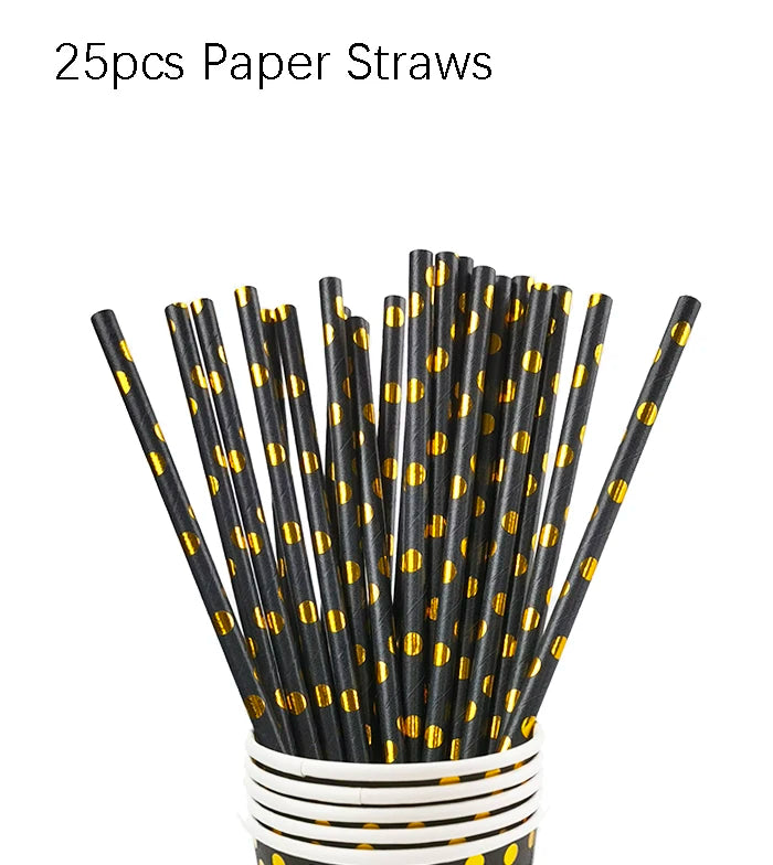 A bundle of 25 paper straws with black and gold polka dots stored in a white cylindrical container.