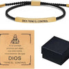 A stainless steel bracelet with a gold-colored nameplate engraved with the phrase Dios tiene el control