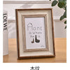 A framed wooden sign with the text Home is Where The Is and a silhouette of a shoe.