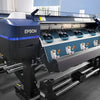 A large Epson printing machine is shown, featuring a blue and black design for canvas art printing.