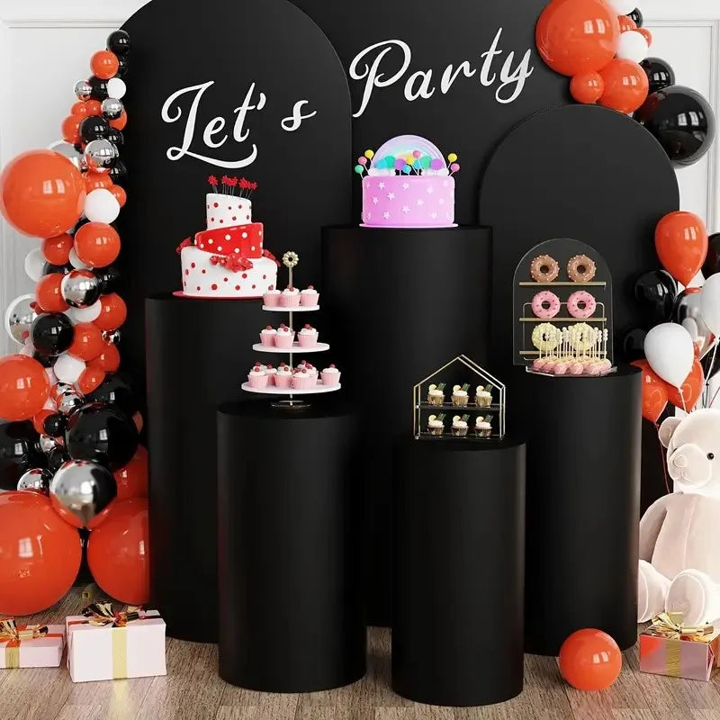 Black cylinder stands decorated with party themes and balloons for event and party decor