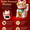 A white cat figurine wearing gold glasses and a green collar, symbolizing solar powered motion and good luck.