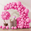 A pink balloon arch display featuring numerous round balloons arranged in an arch shape.