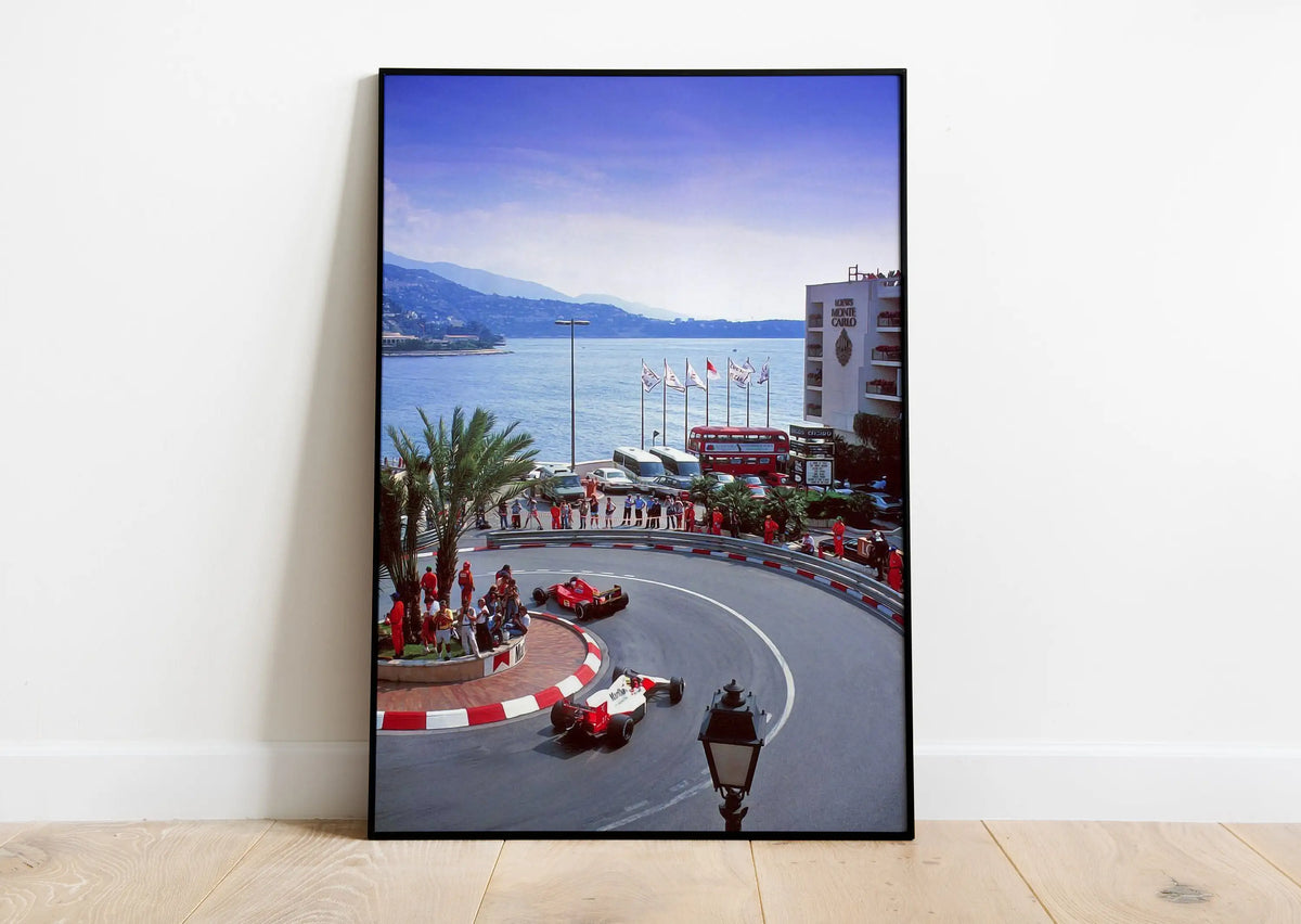 A panoramic photograph of a motorsport racing track with cars on the circuit under a blue sky.