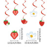 A set of strawberry theme birthday party decorations featuring red strawberries and white flowers.