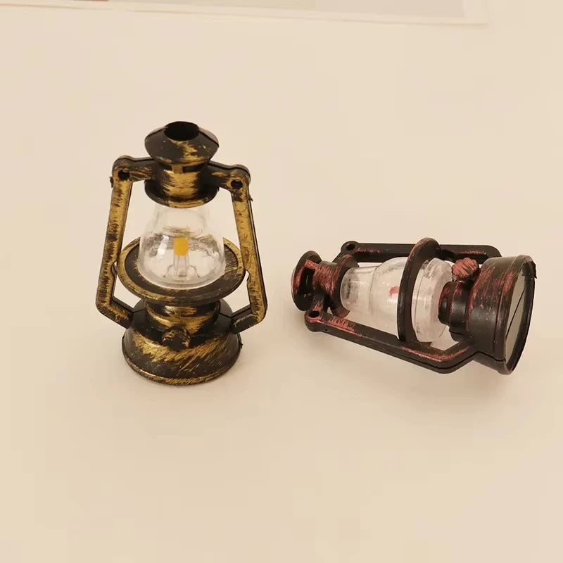 A vintage ceramic miniature lantern with a glass bulb and metal frame for dollhouse décor.