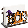 A wooden tissue dispenser shaped like a Boo with black and orange Halloween patterns.