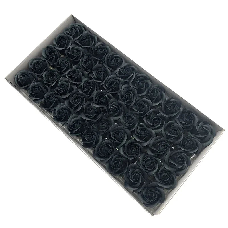 A rectangular tray filled with dark artificial rose flower heads for DIY crafts and decor.