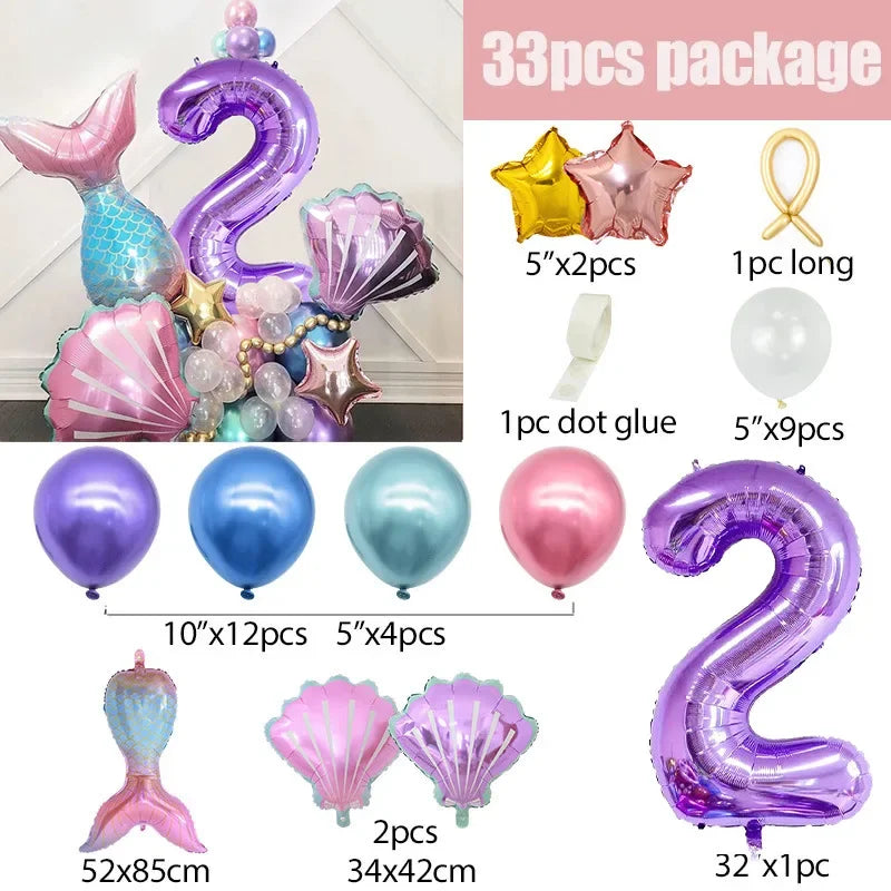 A collection of purple and iridescent balloons shaped like the number 2 and a mermaid tail for party decoration