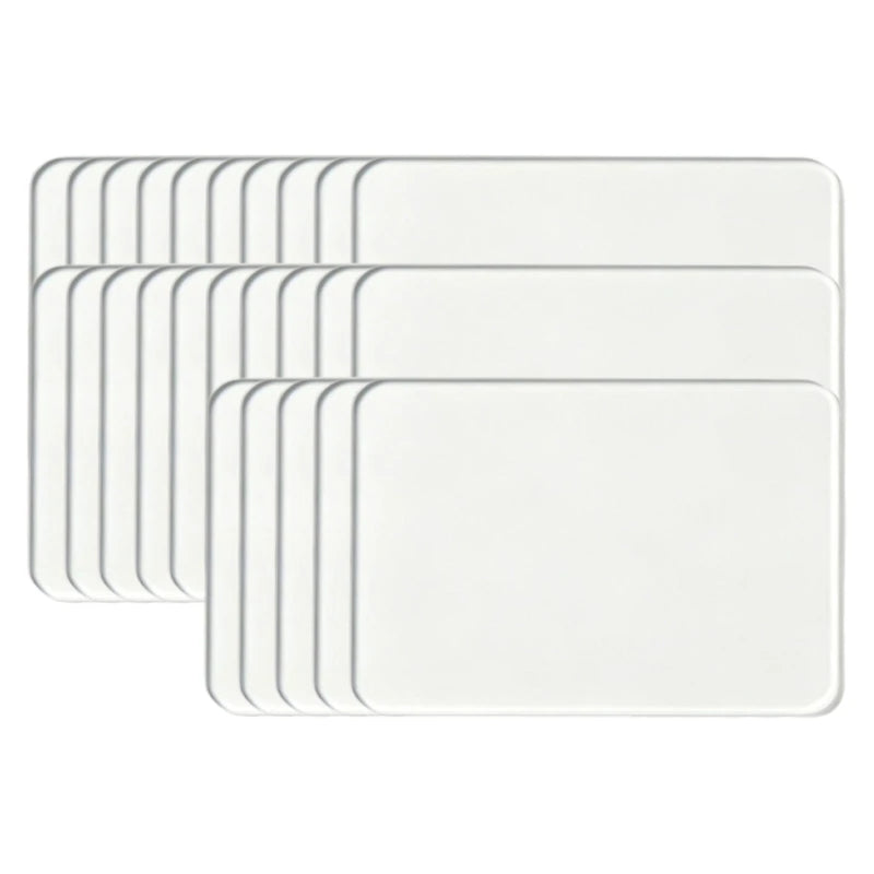 A set of white acrylic fridge magnets with flexible magnetic backing.
