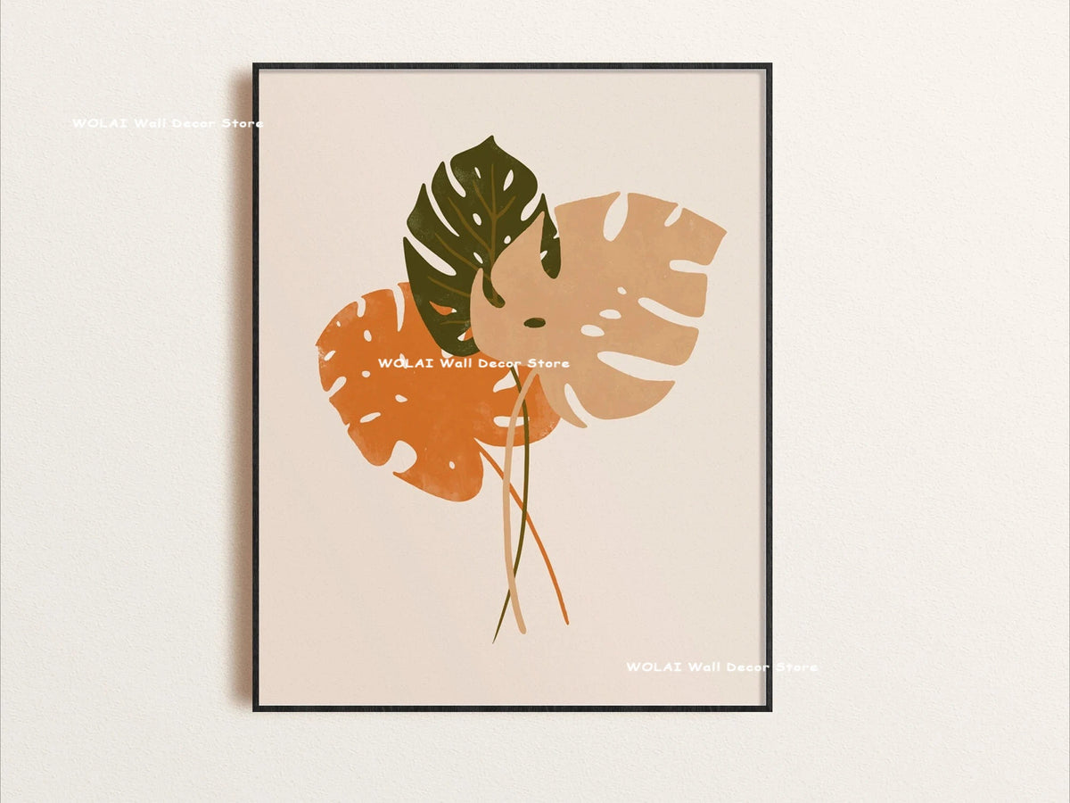 Wall art featuring large, stylized botanical leaves in shades of green and orange on a neutral background.
