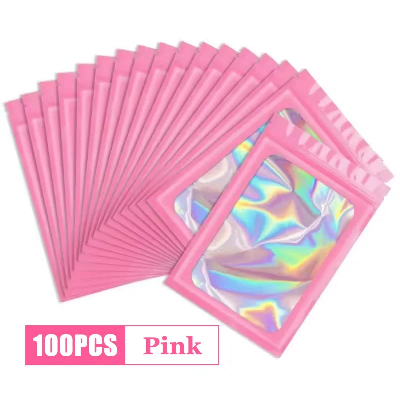 A stack of 100 pink holographic ziplock bags for jewelry and small item storage.