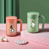 A light green tumbler and a pink tumbler are displayed on a pink surface with a pink textured mat.