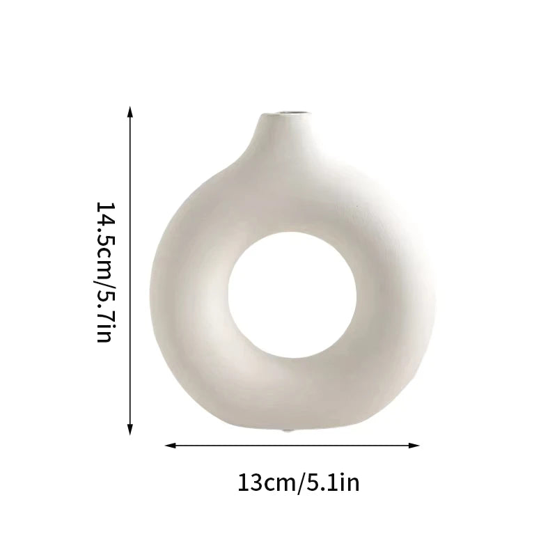 A white ceramic-look vase with a rounded, organic shape shown against a measurement scale.