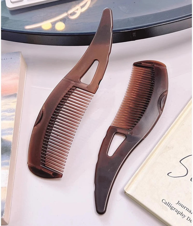 A brown anti-dandruff scalp massage comb with anti-static bristles is shown next to a book.