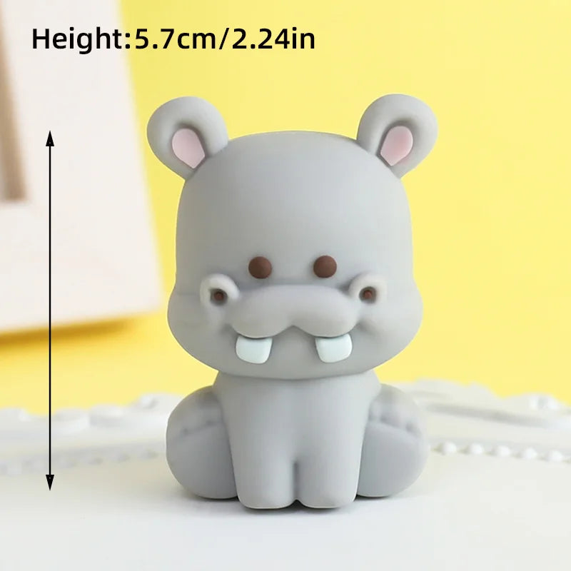 A gray elephant figurine with large ears and a trunk, shown against a light yellow background.