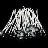 A bundle of white smokeless cotton candle wicks arranged in a fan shape on a dark surface.