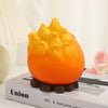 An orange resin fire spirit key tray and desk organizer resting on a white box.