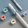 Various colored adhesive wall hooks designed for hanging mops and brushes on a pole.