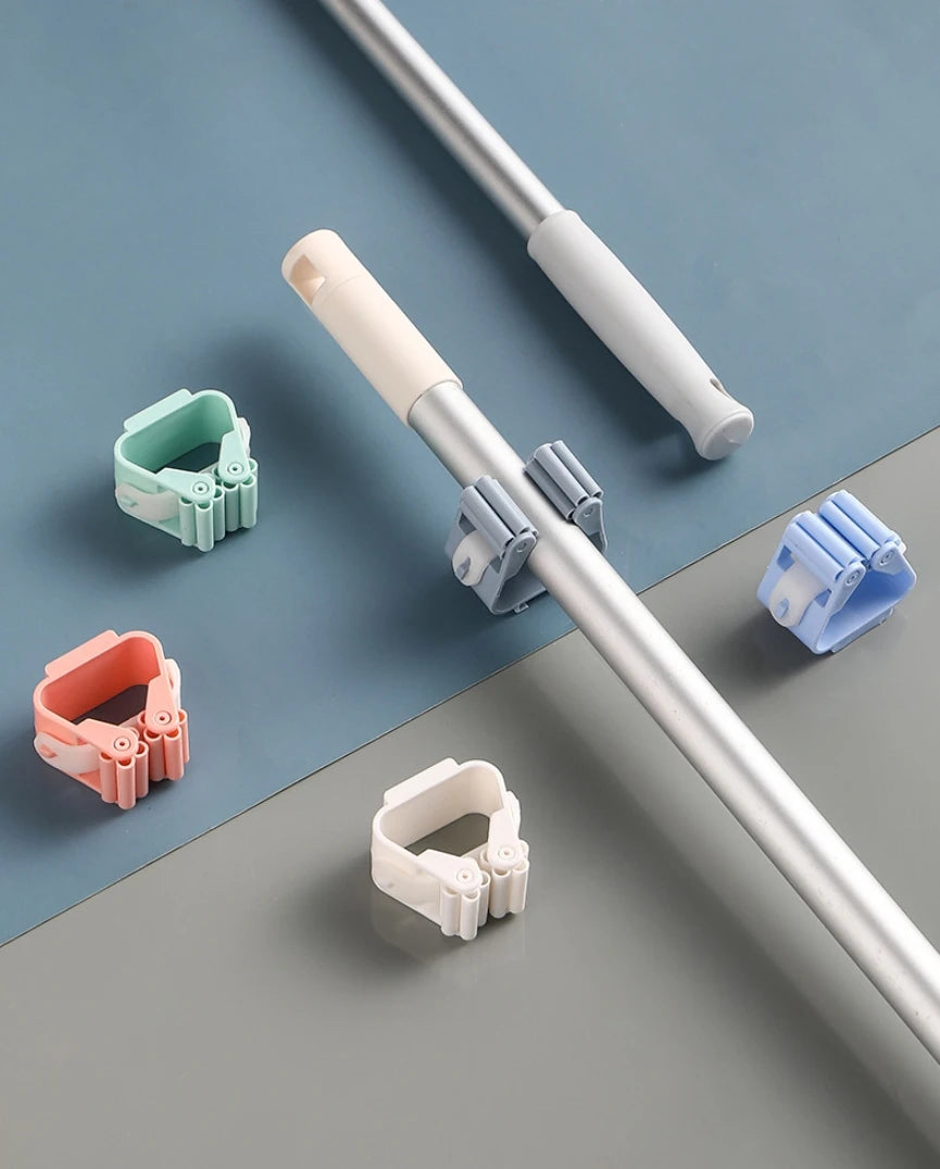 Various colored adhesive wall hooks designed for hanging mops and brushes on a pole.