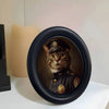 A round black photo frame featuring a portrait of a cat wearing a military-style uniform.