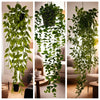 A long, cascading artificial plant featuring vibrant green foliage hanging indoors.