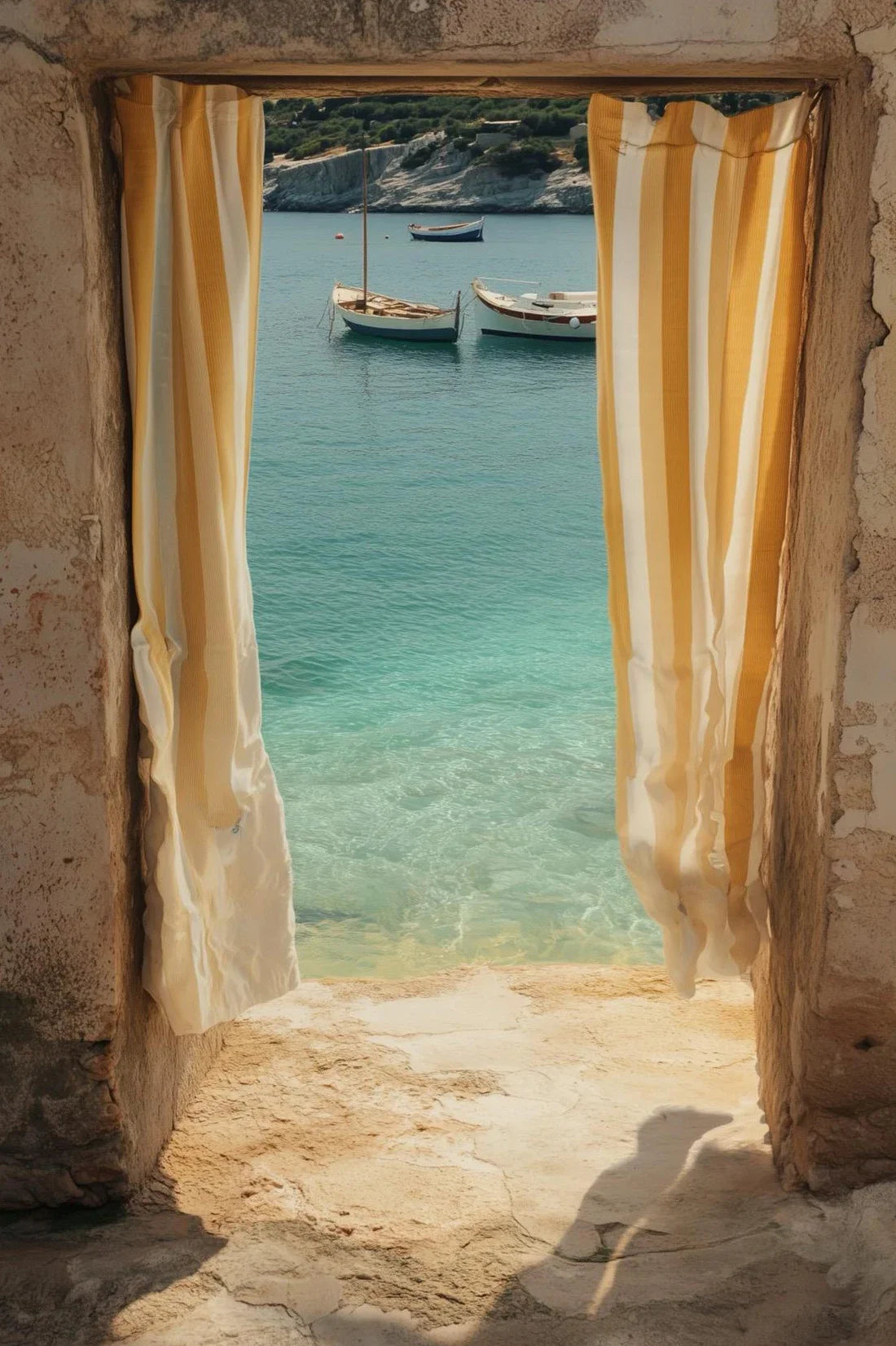 A view through a window with yellow striped curtains showing a turquoise sea and boats.