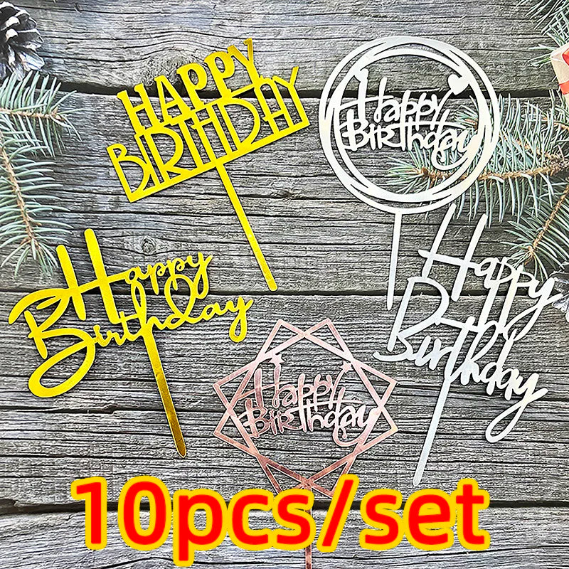 A set of ten acrylic birthday cake toppers in pink and gold colors displayed on a wooden background.