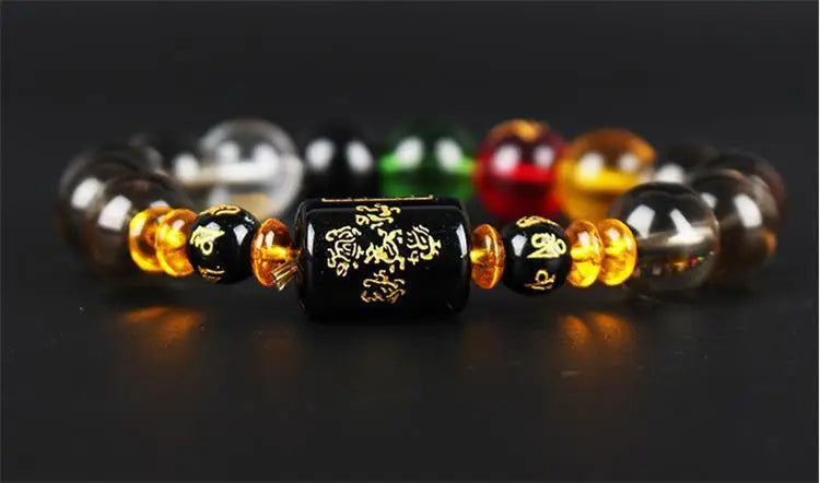 A bracelet made of polished crystal beads in various colors including black, yellow, red, and green.