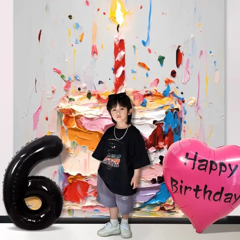 A child stands in front of a colorful paint splatter backdrop featuring a birthday cake and large number six balloons.