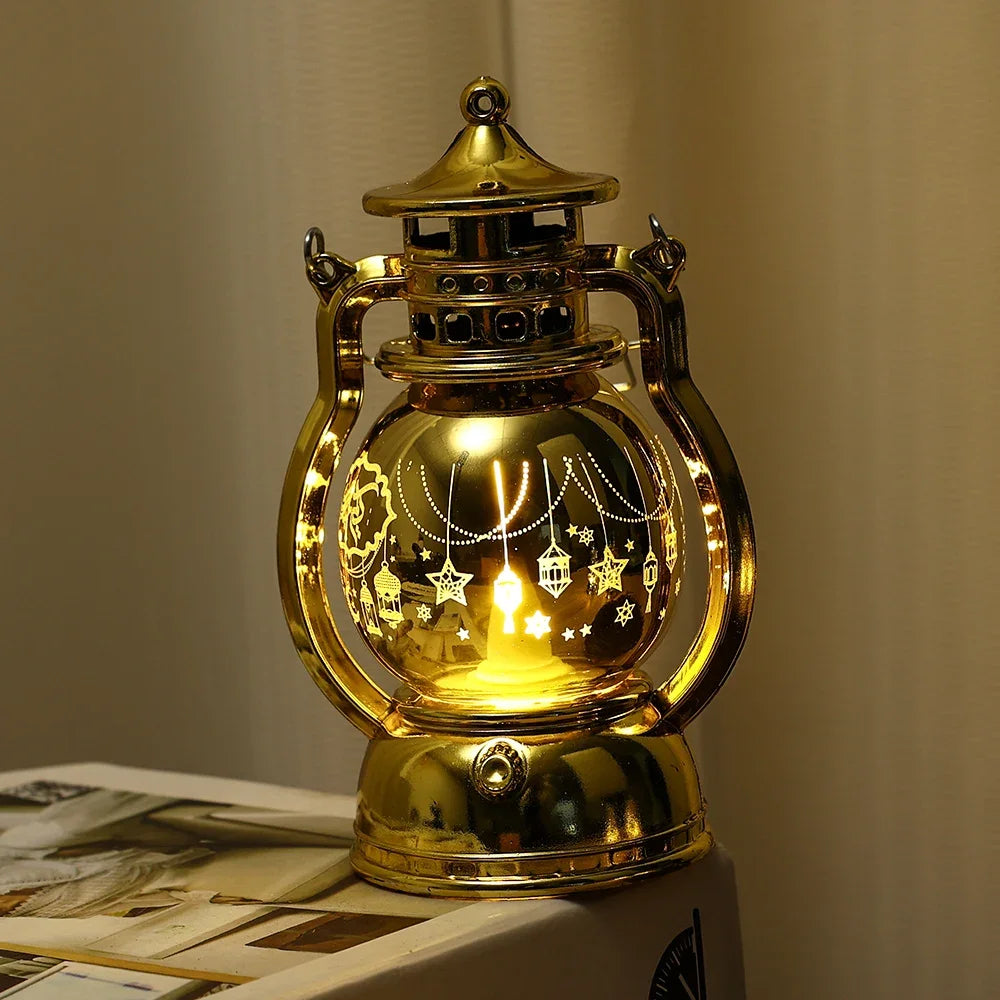 A golden LED lantern night light with a decorative top and a glass globe featuring string lights.