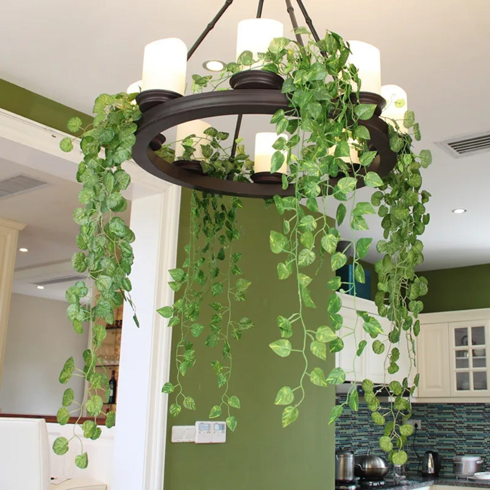 Artificial ivy vine garland hanging as a light fixture in a kitchen or dining area.