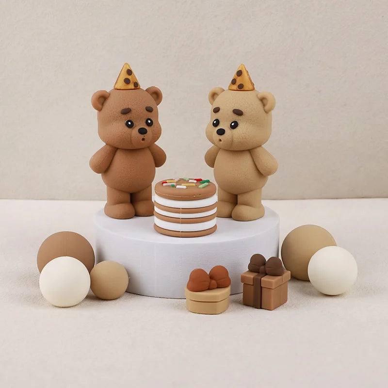 A set of three teddy bear cake toppers, including a full bear, a bear with a cone hat, and small bear figures.