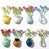 A collection of colorful mini ceramic fridge magnets in various shades including yellow, white, blue, and green.