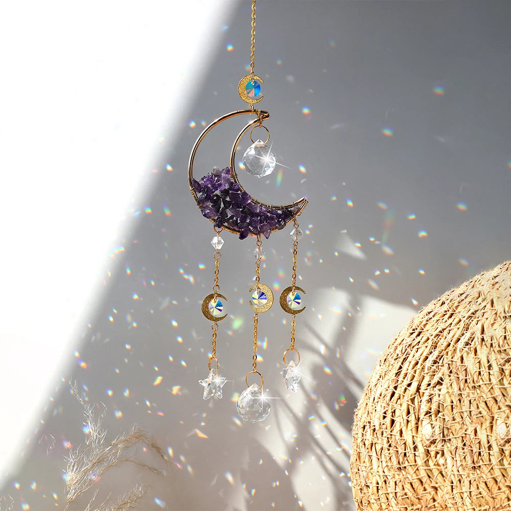 A crystal dreamcatcher sun catcher featuring a purple crescent moon and hanging clear glass charms.