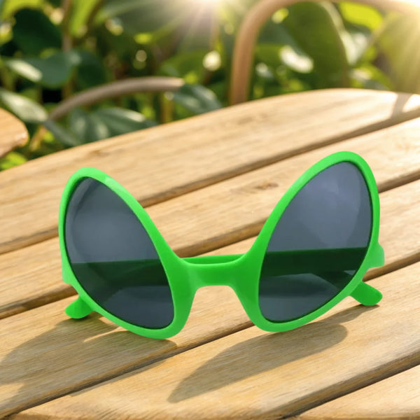 A pair of bright green, quirky sunglasses resting on a wooden surface outdoors.