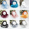 Various rolls of pink silk satin ribbon in different shades and widths displayed on a white background.