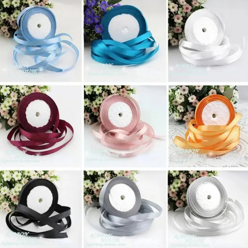 Various rolls of pink silk satin ribbon in different shades and widths displayed on a white background.