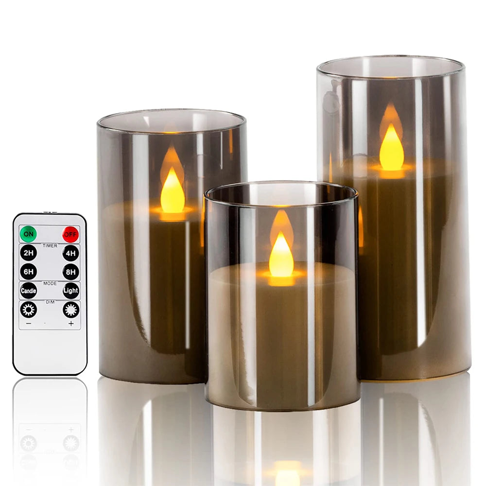 A set of three glass LED flameless candles with flickering flame effects displayed on a reflective surface.