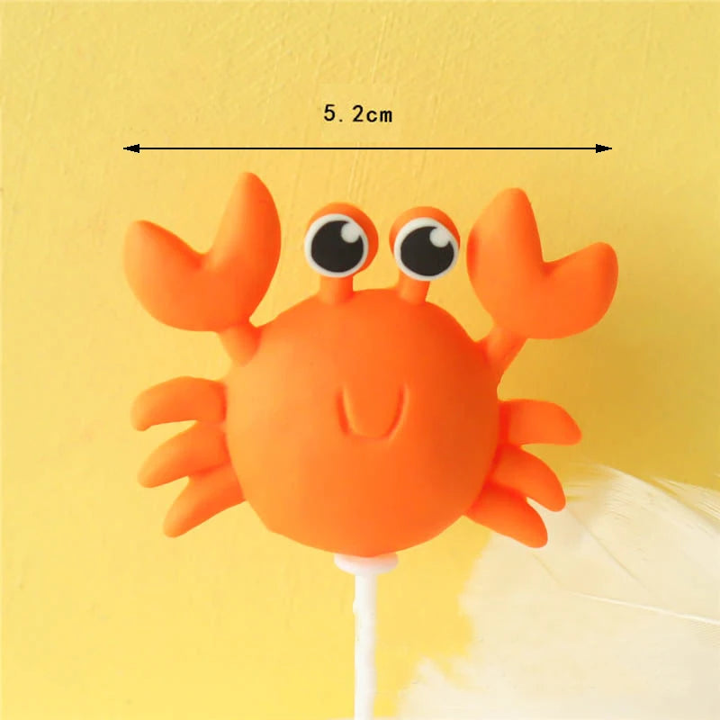 Orange ocean animal cake topper set featuring a crab and other sea creatures on a white stick.